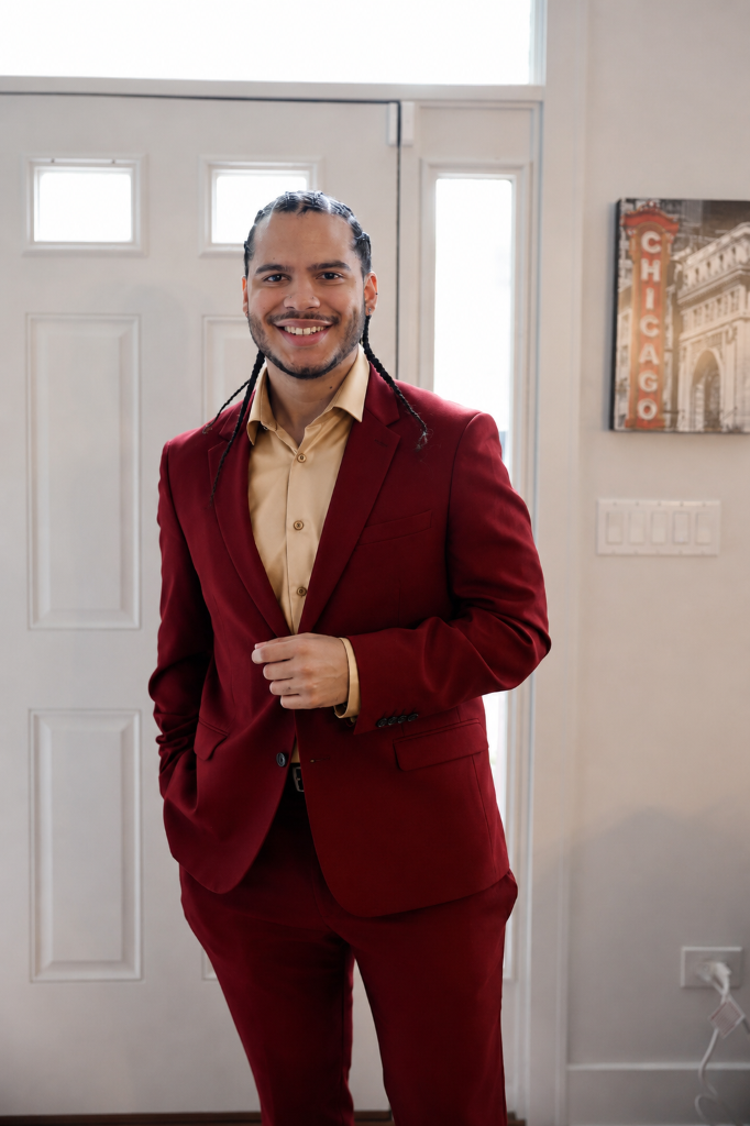 Joshua H. Jimenez in a ruby red suit